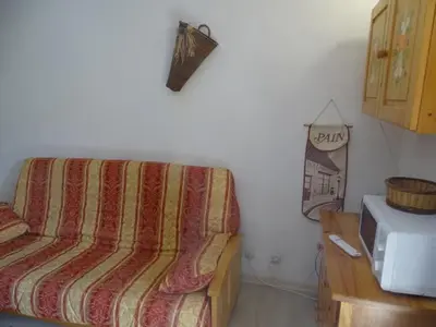 a couch in a corner of a room with a microwave at Studio cosy pour 4 à Samoëns - FR-1-846-22 in Samoëns