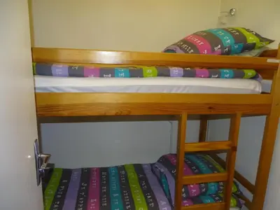 two bunk beds in a room with pillows at Studio confortable pour 4 personnes à Samoëns - FR-1-846-17 in Samoëns