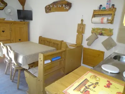 a kitchen with a table and a sink and a table and chairs at Studio confortable pour 4 personnes à Samoëns - FR-1-846-17 in Samoëns