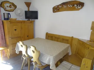 a kitchen with a table and chairs and a tv at Studio confortable pour 4 personnes à Samoëns - FR-1-846-17 in Samoëns