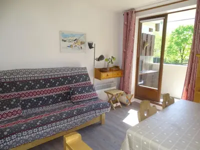 a room with a bed and a table and a window at Studio confortable pour 4 personnes à Samoëns - FR-1-846-17 in Samoëns