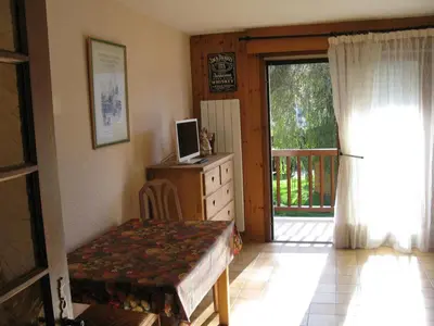 a bedroom with a dresser and a door to a porch at Appartement à Samoëns avec Wifi, idéal pour 3 pers. - FR-1-846-23 in Samoëns