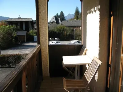 a porch with a table and a chair on a balcony at Appartement à Samoëns avec Wifi, idéal pour 3 pers. - FR-1-846-23 in Samoëns