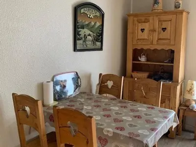 a dining room with a table and chairs and a picture on the wall at Studio cosy à Samoëns pour 4 personnes - FR-1-846-21 in Samoëns