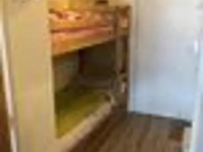 a room with an open cabinet in a kitchen with a wooden floor at Studio cosy à Samoëns pour 4 personnes - FR-1-846-21 in Samoëns