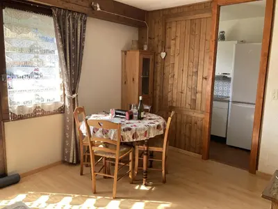 a living room with a table and a blue couch at Appartement cosy pour 2 avec Wifi à Samoëns - FR-1-846-27 in Samoëns
