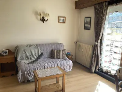 a snow covered building with a mountain in the background at Appartement cosy pour 2 avec Wifi à Samoëns - FR-1-846-27 in Samoëns