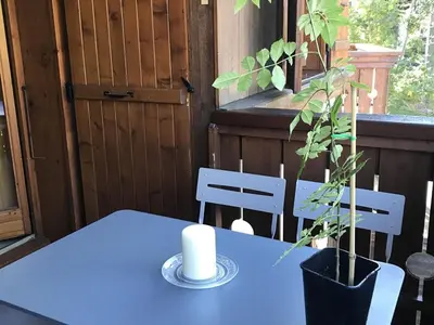 a blue table with two chairs and a plant on it at Charmant appartement avec WiFi à Samoëns - FR-1-846-20 in Samoëns