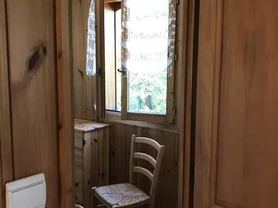 a bathroom with a window and a chair and a toilet at Charmant appartement avec WiFi à Samoëns - FR-1-846-20 in Samoëns