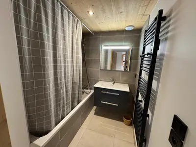 a bathroom with a sink and a shower and a mirror at Appartement spacieux à Samoëns - 8 personnes avec Wifi - FR-1-846-38 in Samoëns