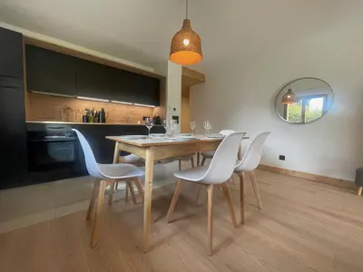 a dining room with a table and chairs in a kitchen at Appartement spacieux à Samoëns - 8 personnes avec Wifi - FR-1-846-38 in Samoëns