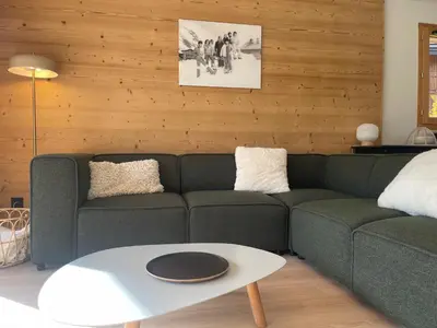 a living room with a couch and a table at Appartement spacieux à Samoëns - 8 personnes avec Wifi - FR-1-846-38 in Samoëns