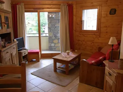 a living room with a couch and a table at Charmant appartement à Samoëns avec wifi et draps inclus - FR-1-846-30 in Samoëns