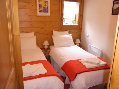a kitchen with wooden cabinets and a stove top oven at Charmant appartement à Samoëns avec wifi et draps inclus - FR-1-846-30 in Samoëns