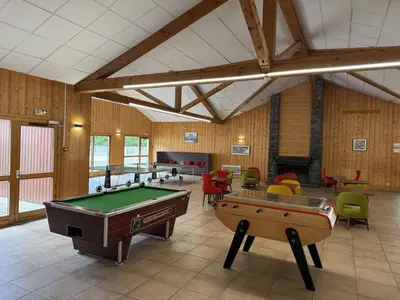 a large room with pool tables and chairs at Appartement cosy 1 chambre - Samoëns - Wifi - FR-1-846-25 in Samoëns