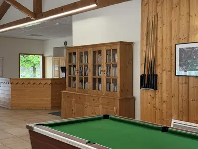a pool table in a room with a library at Appartement cosy 1 chambre - Samoëns - Wifi - FR-1-846-25 in Samoëns