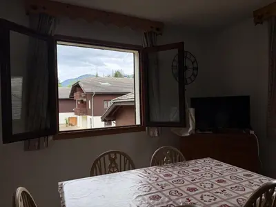 a dining room with a table and a window at Appartement cosy 1 chambre - Samoëns - Wifi - FR-1-846-25 in Samoëns