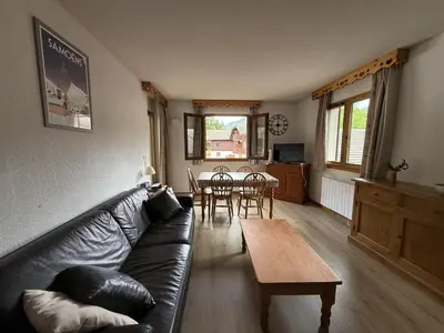 a living room with a couch and a table at Appartement cosy 1 chambre - Samoëns - Wifi - FR-1-846-25 in Samoëns