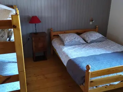 a bedroom with two bunk beds and a lamp at Maison conviviale à Samoëns - 2 chambres, Wi-Fi, pour 6 personnes - FR-1-846-29 in Samoëns