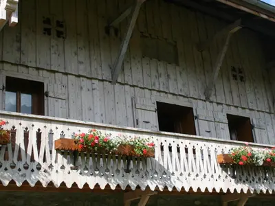a balcony of a building with flowers on it at Maison conviviale à Samoëns - 2 chambres, Wi-Fi, pour 6 personnes - FR-1-846-29 in Samoëns