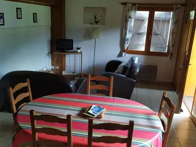 a room with a table and chairs and a living room at Maison conviviale à Samoëns - 2 chambres, Wi-Fi, pour 6 personnes - FR-1-846-29 in Samoëns