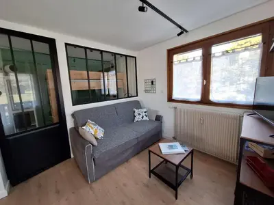 a living room with a couch and a table at Appartement 4 pers. 1 ch. avec lave-linge à Samoëns - FR-1-846-37 in Samoëns