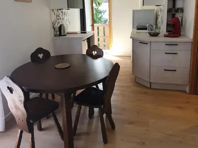 a kitchen with a wooden table and chairs in a kitchen at Appartement 4 pers. 1 ch. avec lave-linge à Samoëns - FR-1-846-37 in Samoëns