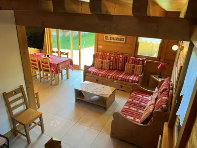 a living room with a couch and a table at Chalet pour 8 avec Wifi à Samoëns - FR-1-846-36 in Samoëns
