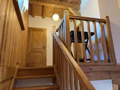 a staircase in a house with wooden walls and ceilings at Chalet pour 8 avec Wifi à Samoëns - FR-1-846-36 in Samoëns