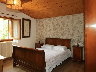 a bedroom with a bed and a wooden ceiling at Charmante Villa à Samoëns avec Wifi et 2 Chambres - FR-1-846-34 in Samoëns