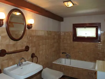 a bathroom with a sink and a tub and a mirror at Charmante Villa à Samoëns avec Wifi et 2 Chambres - FR-1-846-34 in Samoëns