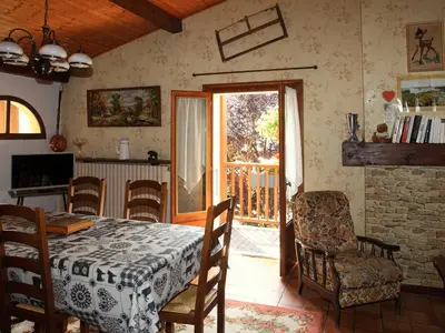 a dining room with a table and chairs and a balcony at Charmante Villa à Samoëns avec Wifi et 2 Chambres - FR-1-846-34 in Samoëns