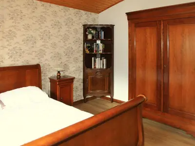 a bedroom with a bed and a book shelf at Charmante Villa à Samoëns avec Wifi et 2 Chambres - FR-1-846-34 in Samoëns