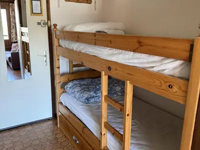 a couple of bunk beds in a room at Studio Samoëns - 4 pers, cosy & pratique - FR-1-846-33 in Samoëns
