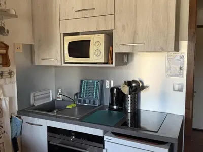 a kitchen with a sink and a microwave at Studio Samoëns - 4 pers, cosy & pratique - FR-1-846-33 in Samoëns