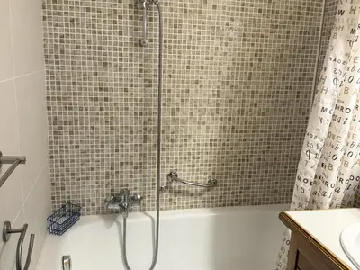 a bathroom with a shower and a tub with a sink at Studio Samoëns - 4 pers, cosy & pratique - FR-1-846-33 in Samoëns