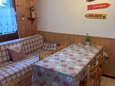 a room with a table and a couch at Charmant appartement avec Wifi à Samoëns - FR-1-846-35 in Samoëns