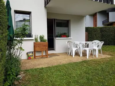 a white table and chairs in the backyard of a house at Charmant appartement avec Wifi à Samoëns - FR-1-846-35 in Samoëns