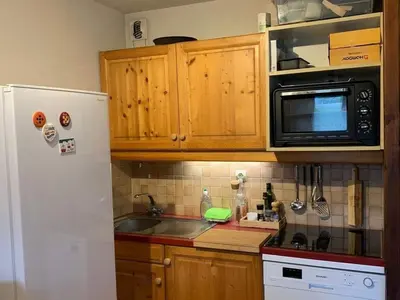 a kitchen with a white refrigerator and a microwave at Charmant appartement avec Wifi à Samoëns - FR-1-846-35 in Samoëns