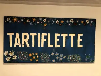 a sign that reads cafeteria with flowers on a wall at Appartement Phoebe, Chamonix Centre in Chamonix-Mont-Blanc