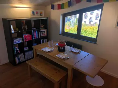 a wooden table in a room with a window at Appartement Phoebe, Chamonix Centre in Chamonix-Mont-Blanc