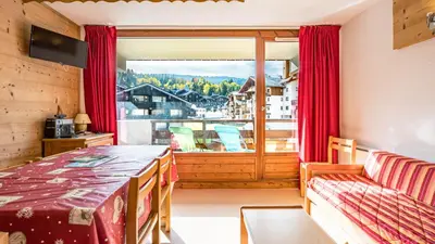a room with a table and a large window at Les Eterlous N24 2P6 in Morillon