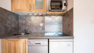 a small kitchen with a sink and a microwave at Les Eterlous N24 2P6 in Morillon