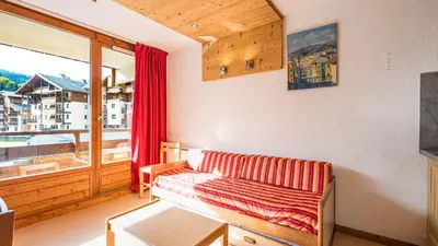 a living room with a couch and a large window at Les Eterlous N24 2P6 in Morillon