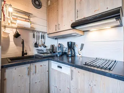 a kitchen with wooden cabinets and a counter top at Grand Horizon 1 N403 2P8 in Morillon