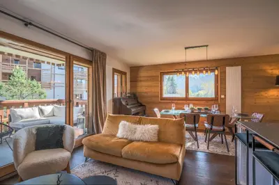 a living room with a couch and a table at Appartement Prariand - Welkeys in Megève
