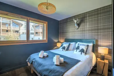 a bedroom with a bed with two towels on it at Appartement Prariand - Welkeys in Megève
