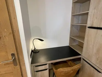 a desk next to a door with a lamp at Appartement de standing 3 chambres au centre, pied de piste, parking et WIFI - FR-1-836-5 in Arâches-la-Frasse