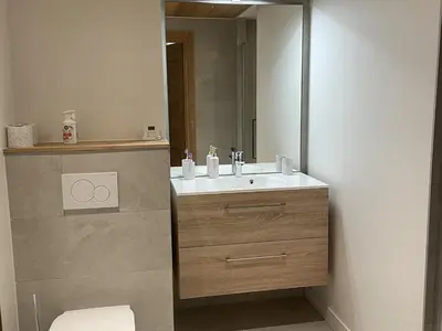 a bathroom with a sink and a mirror at Appartement de standing 3 chambres au centre, pied de piste, parking et WIFI - FR-1-836-5 in Arâches-la-Frasse