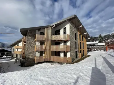 a apartment building in the snow in the winter at Appartement de standing 3 chambres au centre, pied de piste, parking et WIFI - FR-1-836-5 in Arâches-la-Frasse